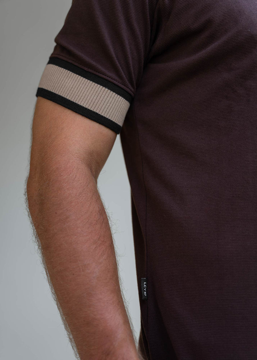 Model wearing an LCY Polo, with contrast ribbed and cuffs
